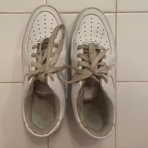 Worn, white Nike Air Force 1 low casual shoe